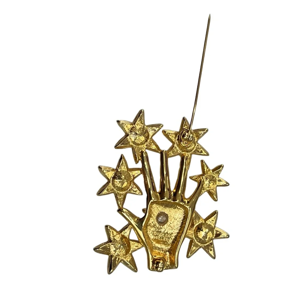 NOLAN MILLER SHINY GOLDEN HAND WITH CRYSTAL STARS BROOCH